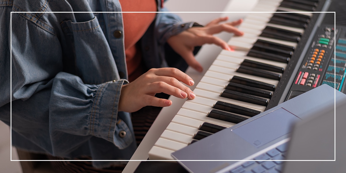 Playing piano as they attend the music program at Three20 Recovery